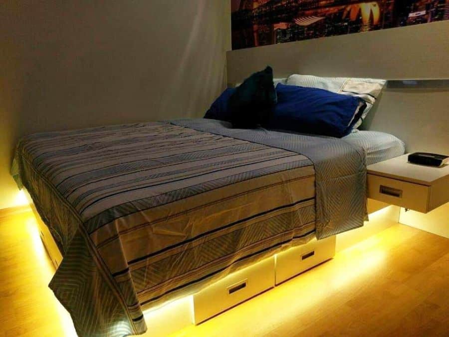 Bed with under-bed storage drawers and warm LED lighting.