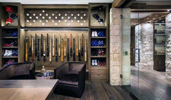 Baseball-themed mancave with bat display, shelves of shoes and helmets, and modern seating area.