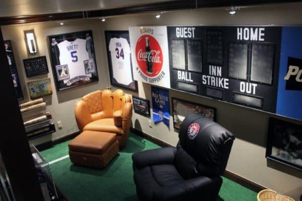 Cozy sports-themed mancave with leather chairs, framed jerseys, vintage scoreboard, and memorabilia.