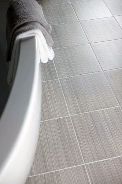 Bathroom with light grey square tiles and white grout