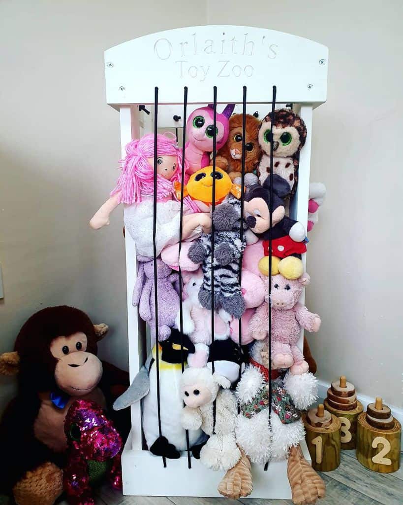 Stuffed animal holder labeled "Toy Zoo" with assorted plush toys.