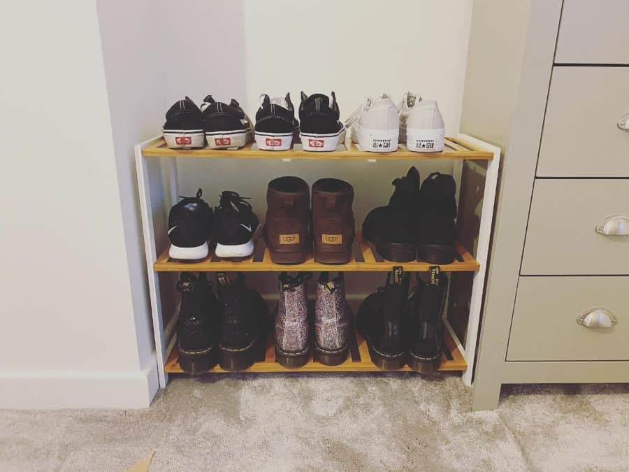 Three-tier shoe rack with various shoes neatly organized.