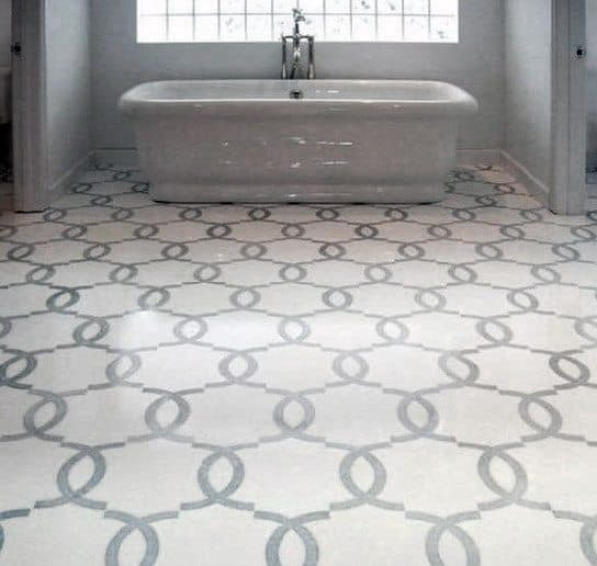 Modern bathroom with a grey freestanding tub and geometric patterned floor tiles