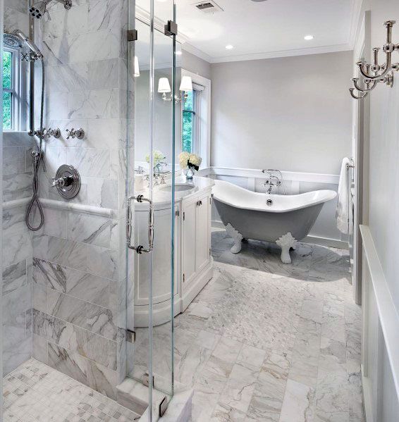 Elegant bathroom with a glass shower, clawfoot tub, and marble tiles, bright and airy with natural light