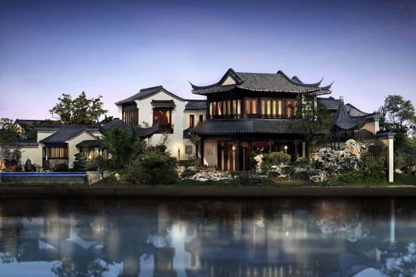 Taohuayuan House in Suzhou, a traditional Chinese mansion with a pond reflection.