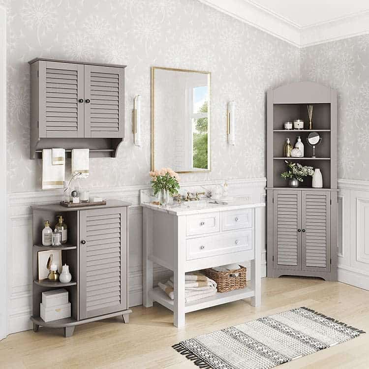 Country-style bathroom with grey cabinets, white vanity, and floral wallpaper.