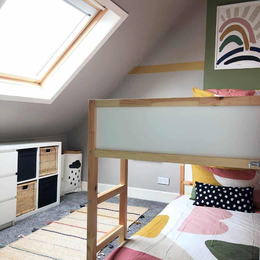 Attic bedroom with bunk beds, skylight, colorful bedding, and woven basket storage.