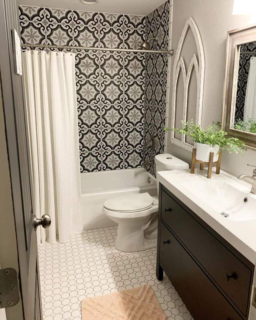 Bathroom with church-inspired decor, patterned wallpaper, and hexagon tile flooring.