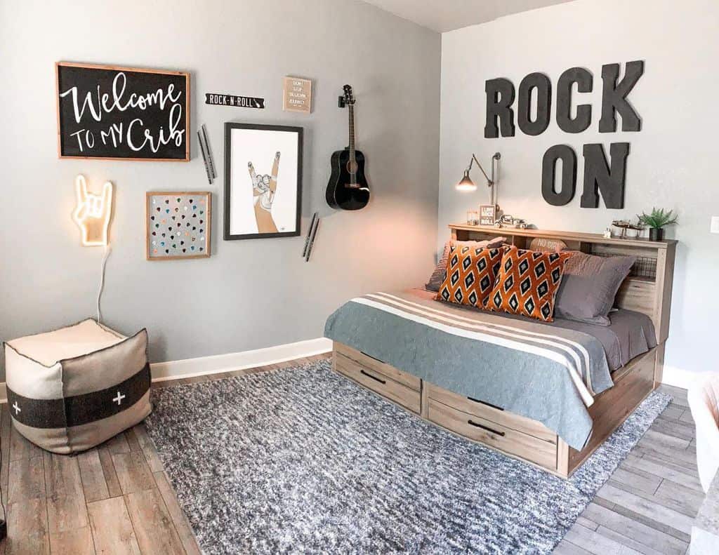 Kids' bedroom with "Rock On" wall art, wooden bed, gray rug, and musical decor.