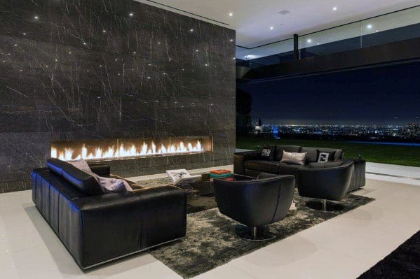 Living room with a sleek linear gas fireplace set in a black marble wall.