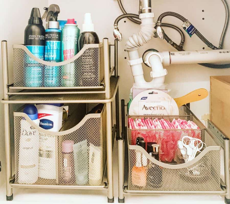 Under-sink bathroom storage with mesh drawers organizing hair products and personal care items.