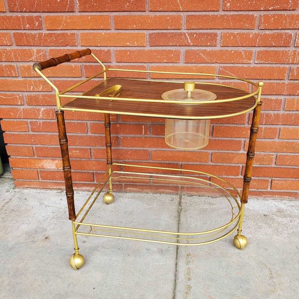 Vintage gold bar cart with wood accents, bamboo-style legs, and a built-in ice bucket.