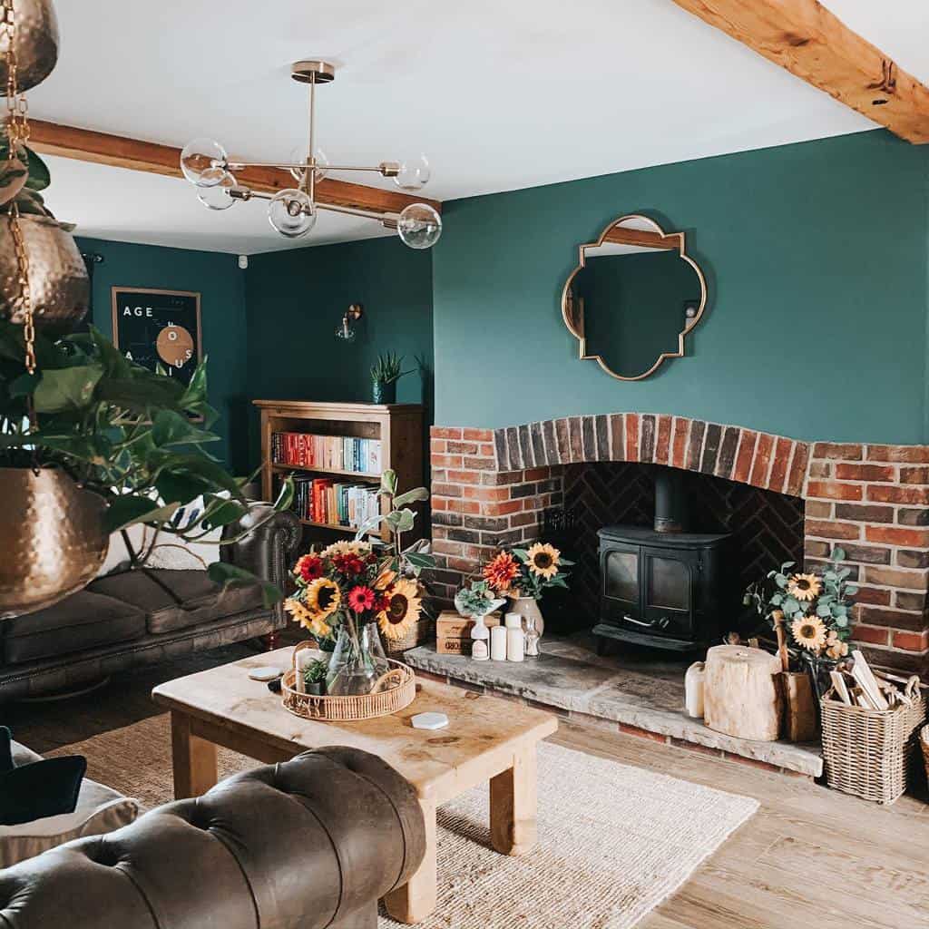 Rustic sunroom with exposed brick fireplace, cozy leather seating, and vibrant sunflower accents.