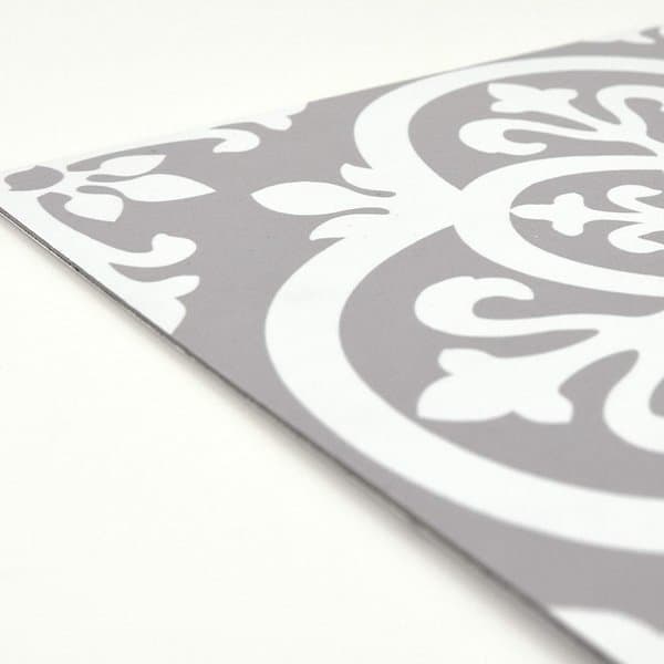 Gray and white vinyl flooring with a bold floral medallion pattern and smooth surface finish.