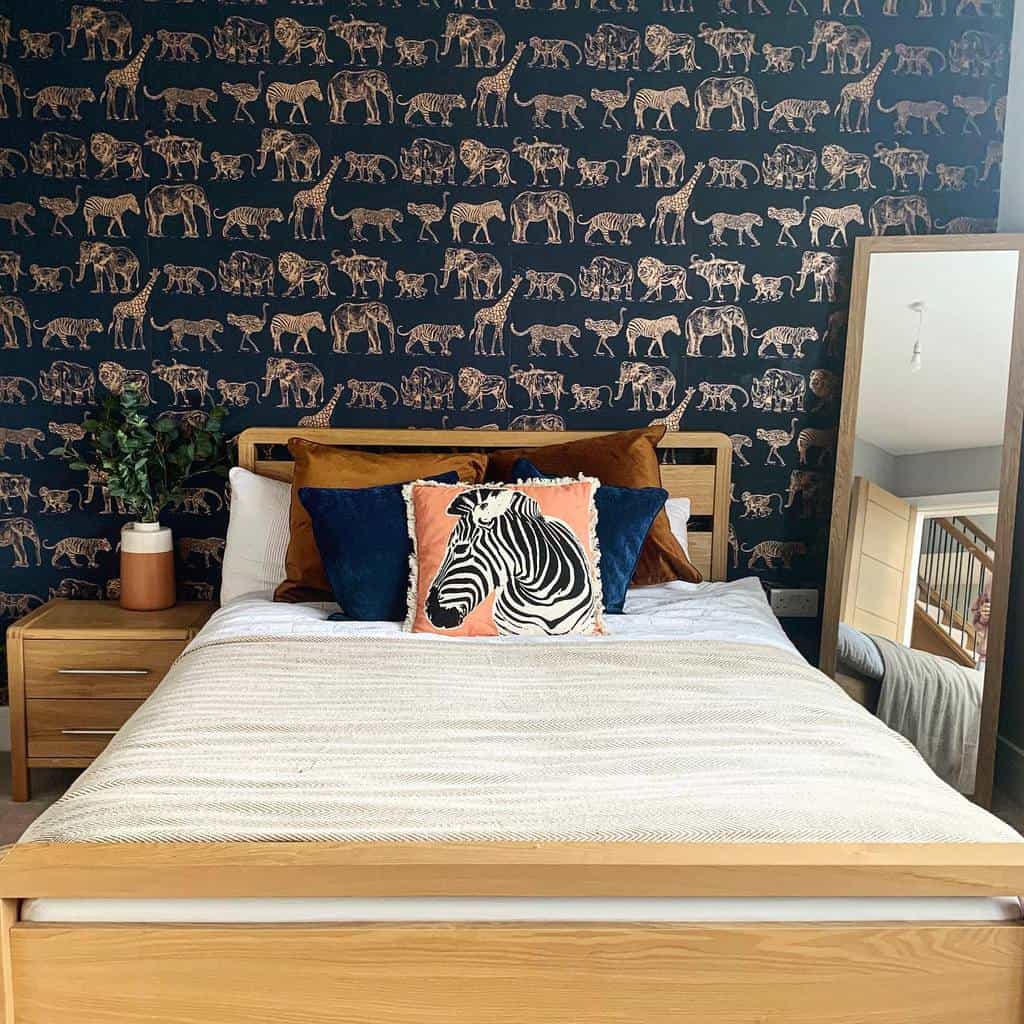 Bedroom with metallic animal print wallpaper, wooden bed, and zebra-themed cushions.