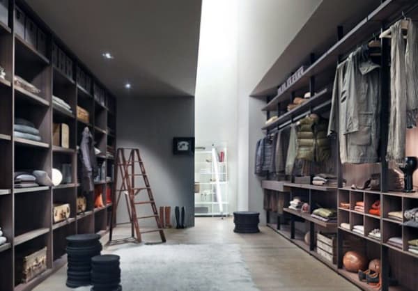 Spacious walk-in closet with shelves, clothes, and packed storage boxes, featuring a wooden ladder in the center