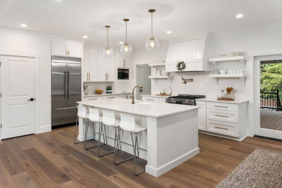 large white kitchen with wood vinyl flooring 