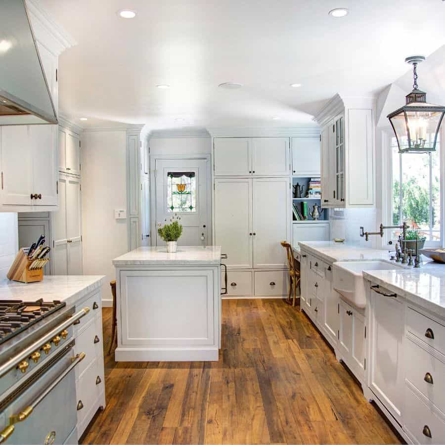 rustic white cabinet farmhouse kitchen with apron sink and island 