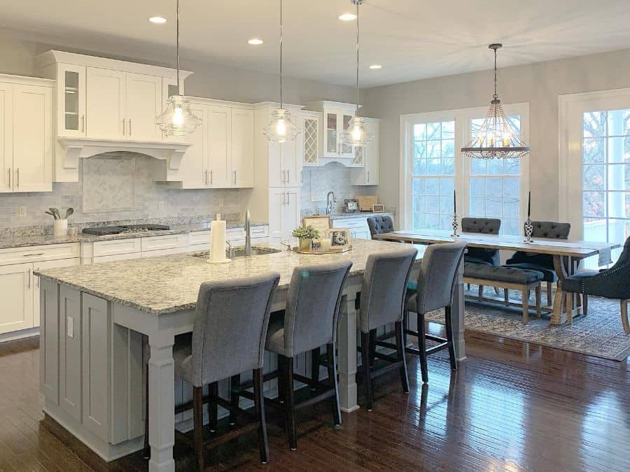 large white kitchen with gray island and seats 