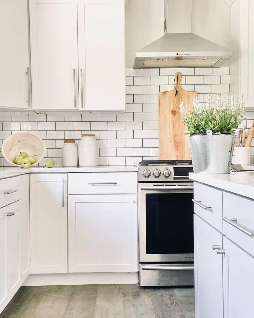 farmhouse kitchen with white cabinets and tile backsplash 