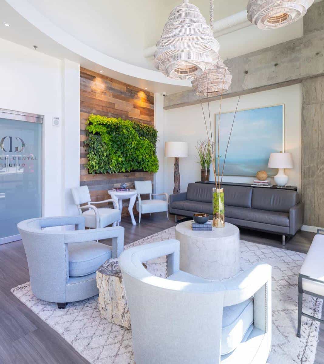 foyer with gray sofa and white chairs 