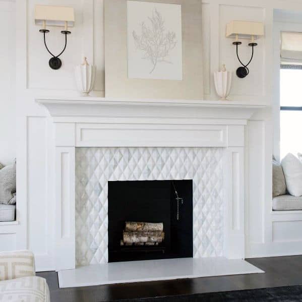 A bright and elegant fireplace featuring white diamond-patterned tiles, framed by a classic mantle and flanked by built-in seating.