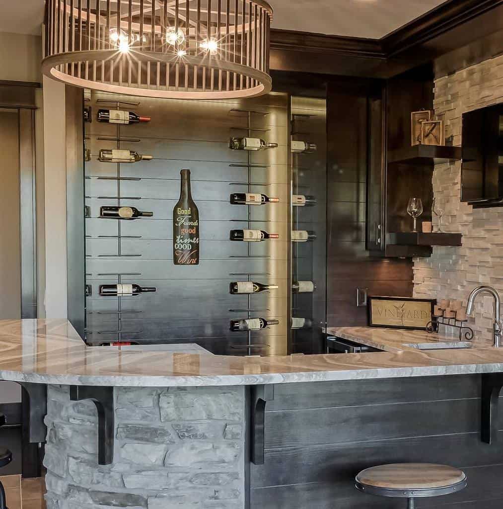 Rustic-chic wet bar featuring a stone countertop, modern wine wall, and warm accent lighting for a cozy yet elegant vibe.