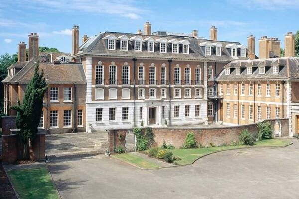 Witanhurst Mansion with a red-brick facade, white accents, and a large courtyard.