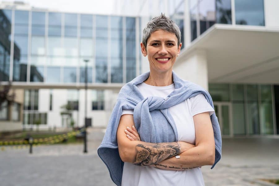 woman in a short gray hair tattoo on hand