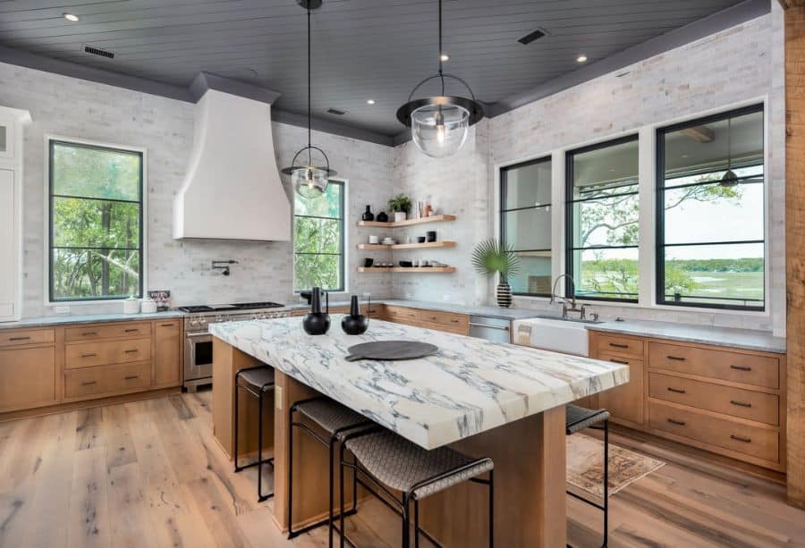 large corner wood kitchen with marble countertops 