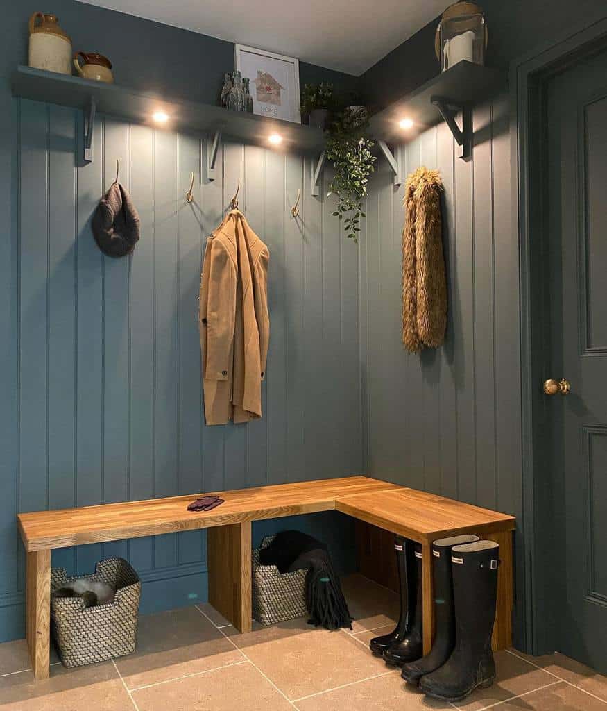 gray wood wall paneling wood bench hanging coats 