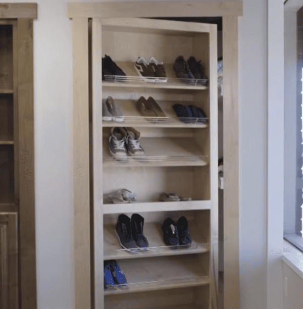 Wooden sliding door with built-in shelves for shoe storage, featuring a minimalist design perfect for space-saving solutions